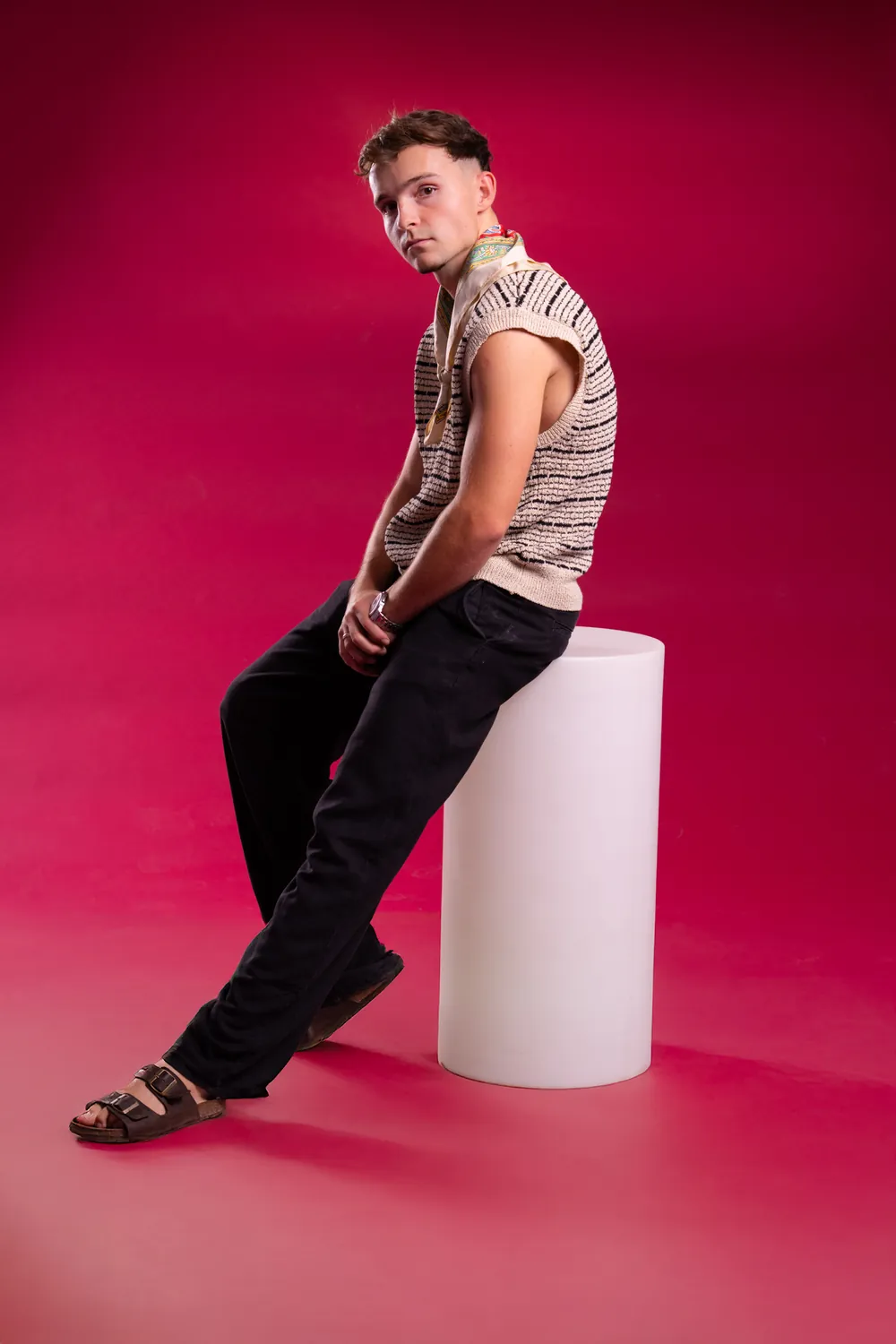 Kotto seated on a plinth